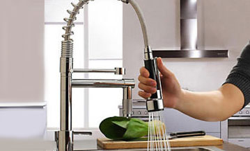 Kitchen mixer tap in use
